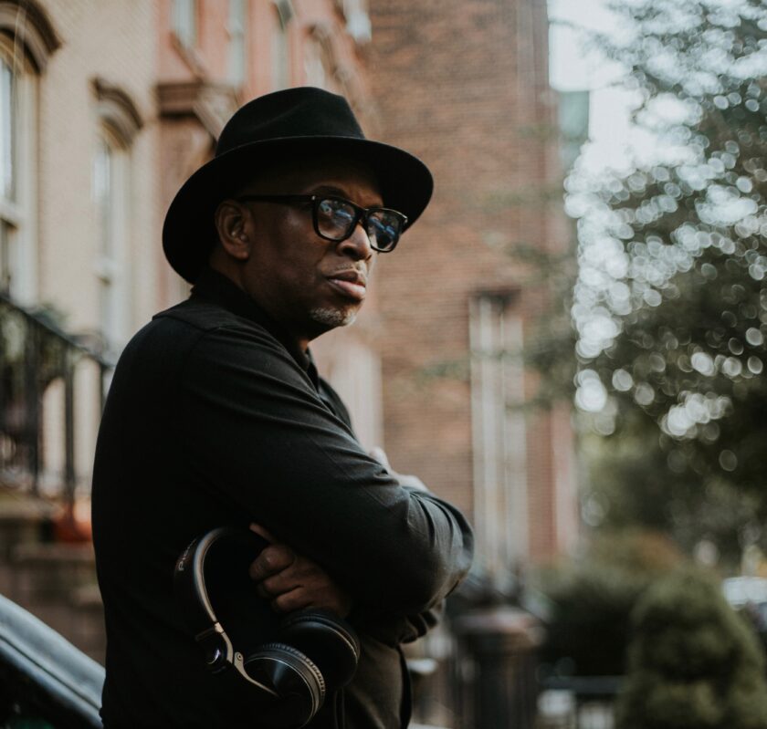 the Legendary DJ Belal Miller standing in all black with headphones ready in NYC.